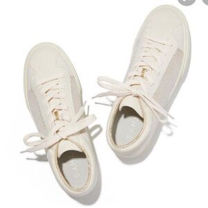 Rothy’s lace up white sneaker with gold accent